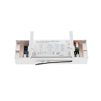Rectangular dimmable RF controller with labelled technical information, input-output data, symbols and a connected wire visible on its surface for LED illumination.